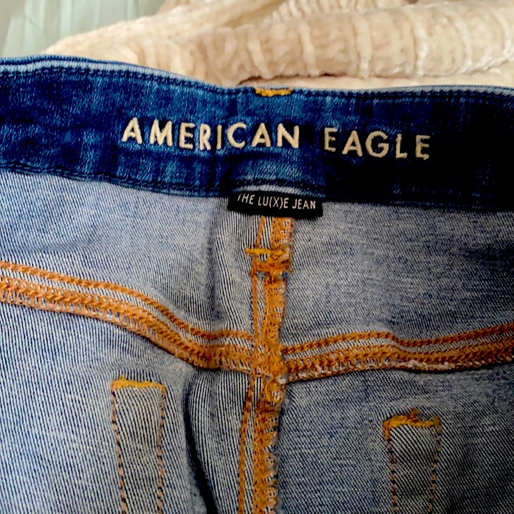 Slightly distressed luxe jegging in a medium wash. Size 12 long
